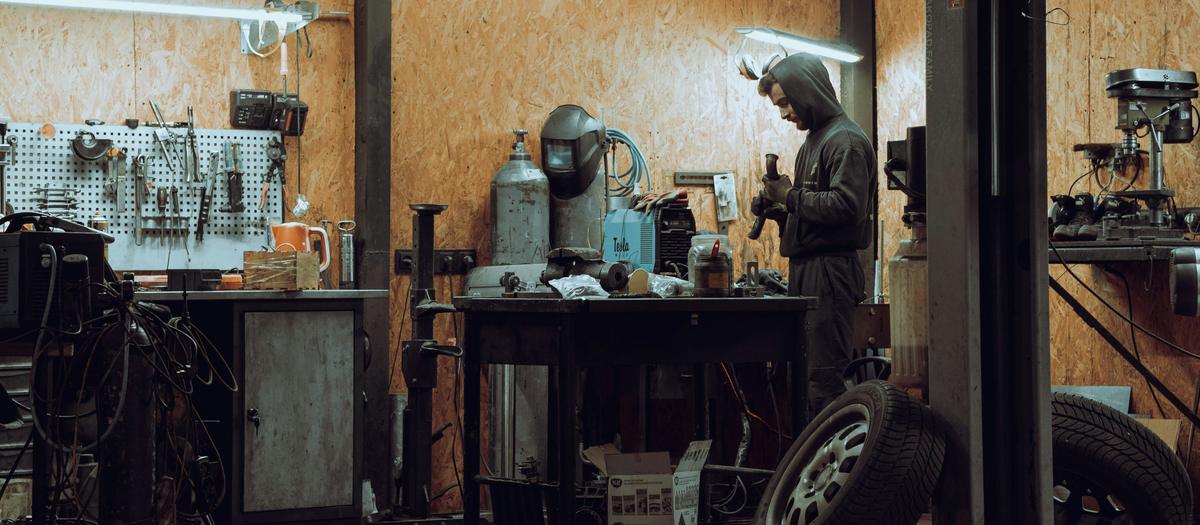 Independent auto repair garage with lift where technicians have group health insurance