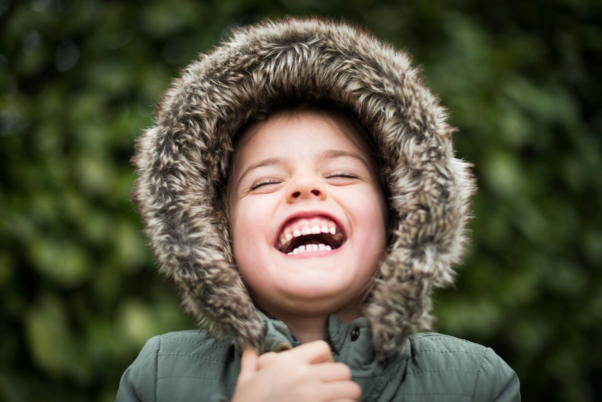 Child laughing with a big healthy smile