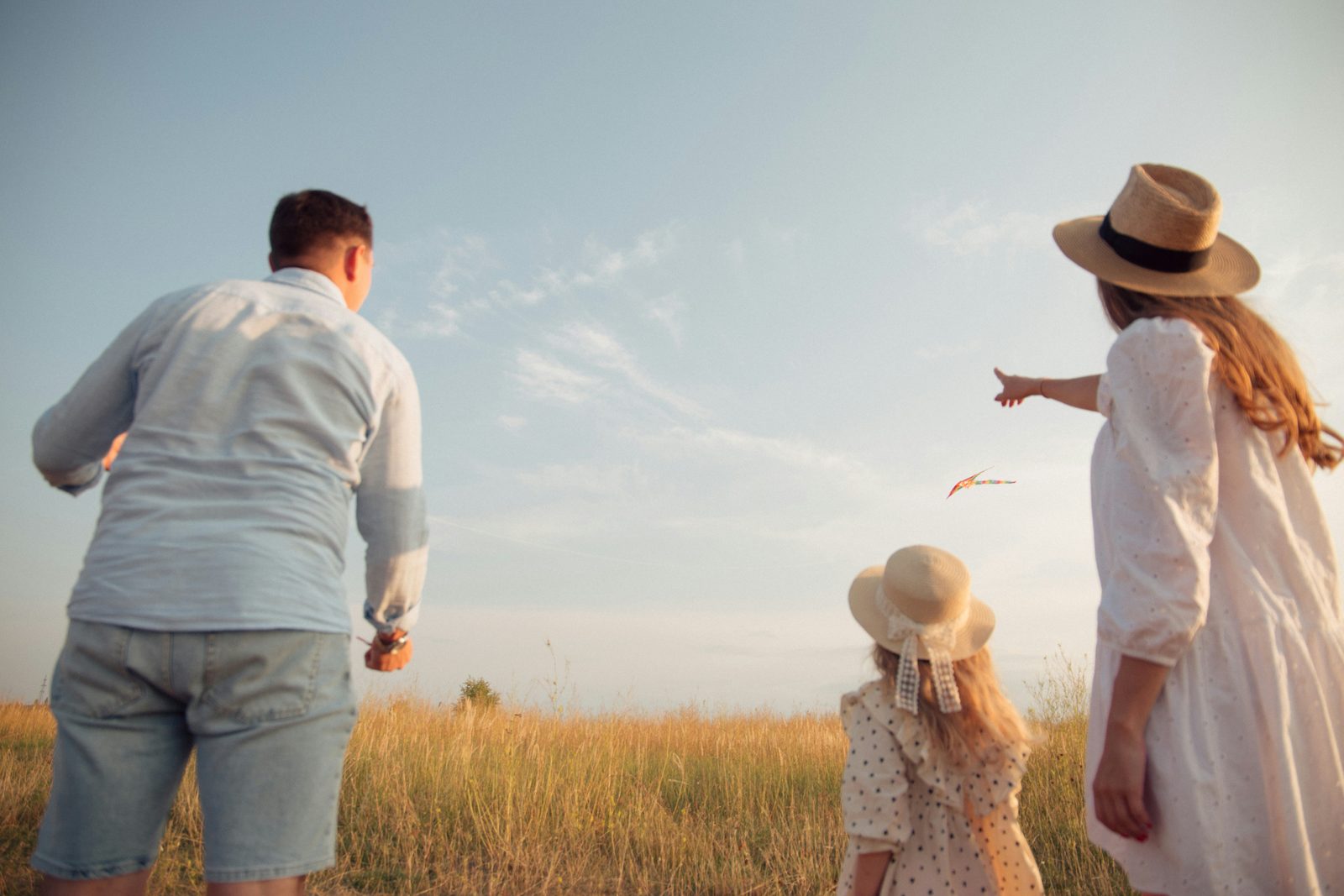 Family flying a kite in an open field after sorting out their 2026 health insurance cost