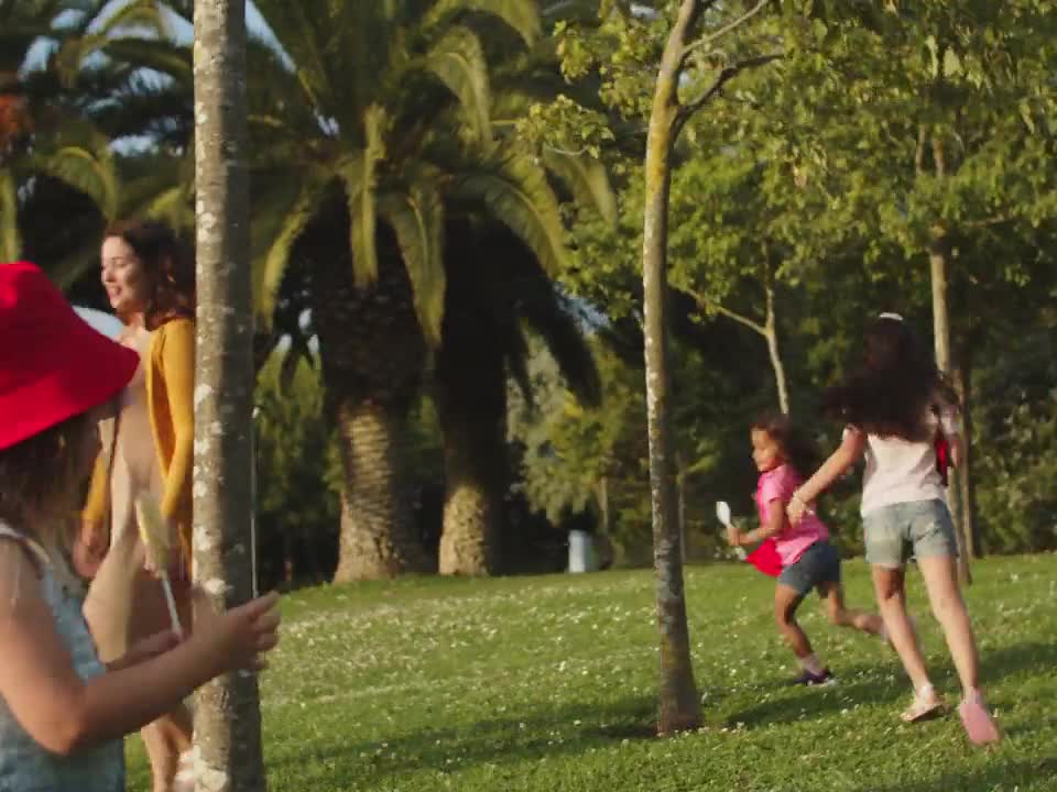 Mother and kids playing together in a sunny park