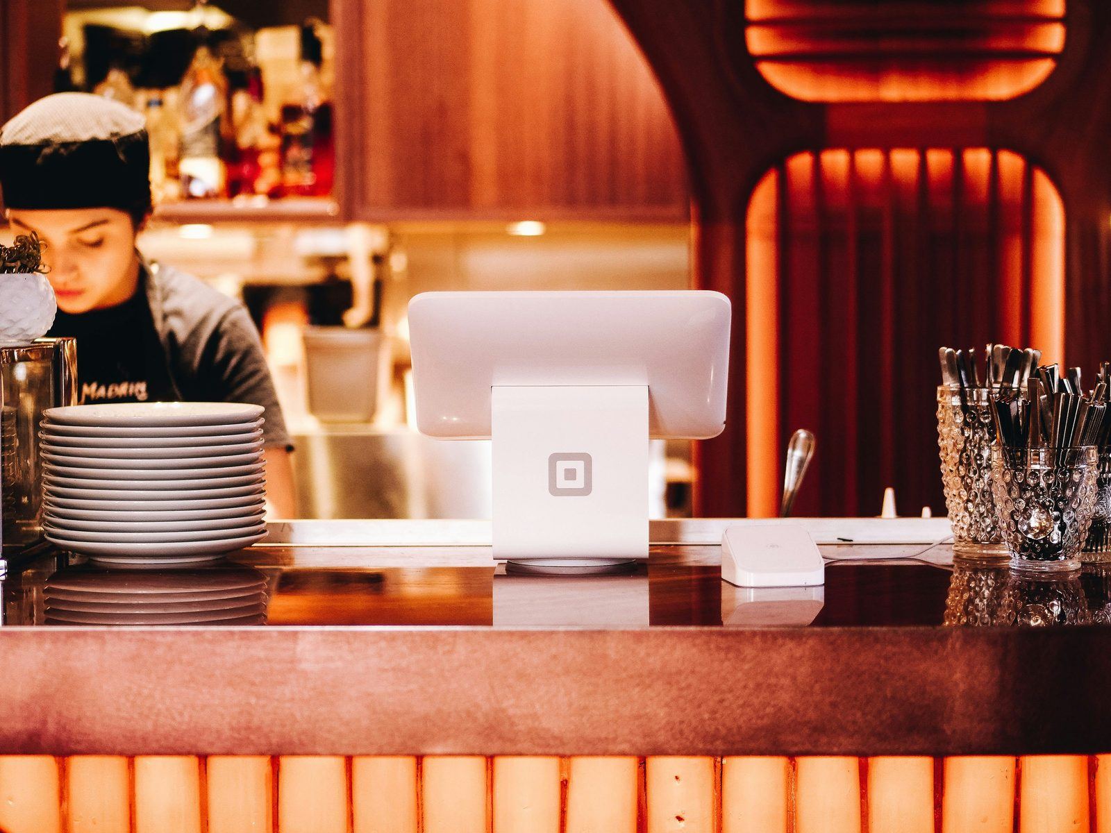 Point-of-sale terminal on a restaurant bar, representing restaurant owner benefit decisions
