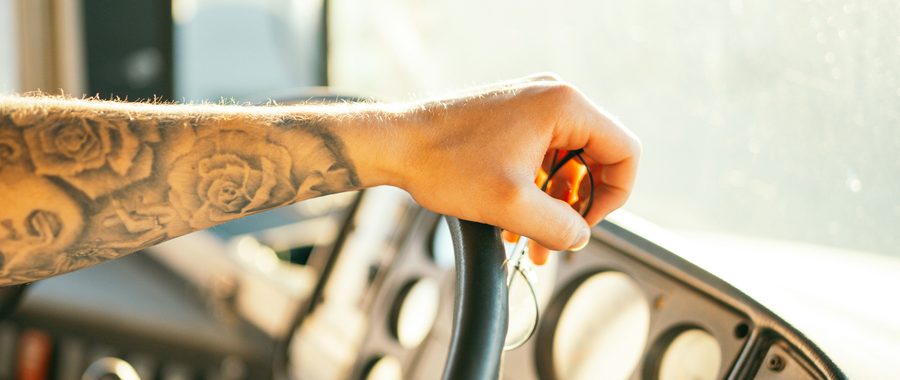 Driver at the wheel at sunrise
