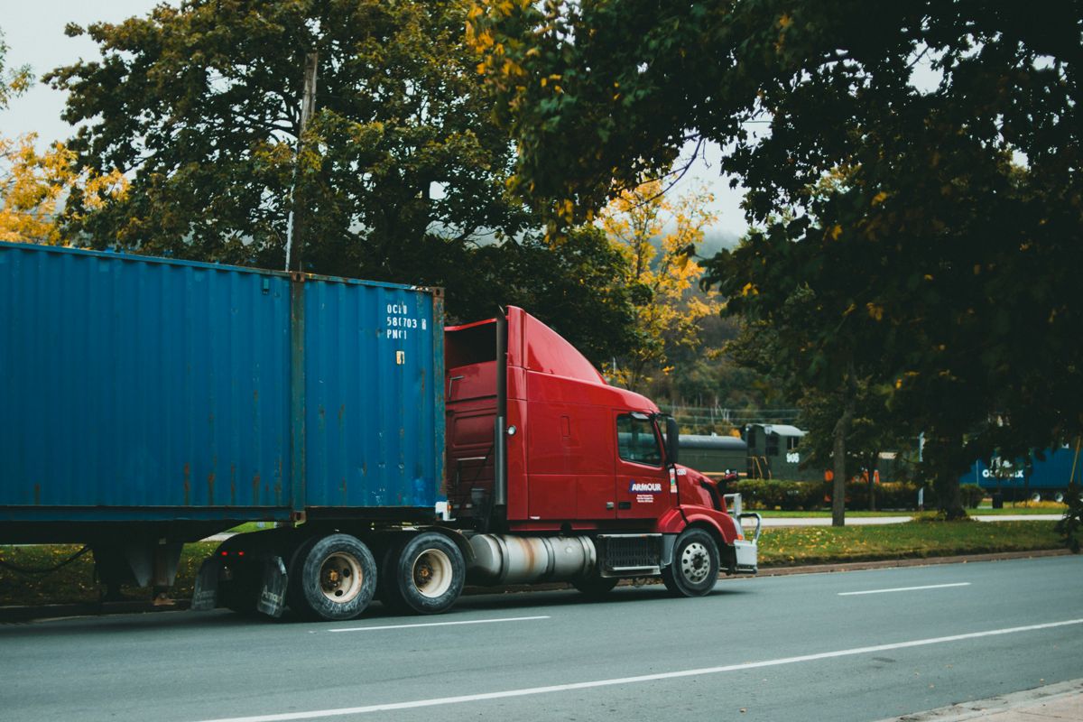 Small trucking company truck on a Florida highway, representing driver retention and benefits strategy