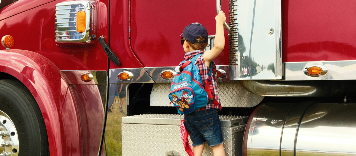 Truck driver with child beside the truck