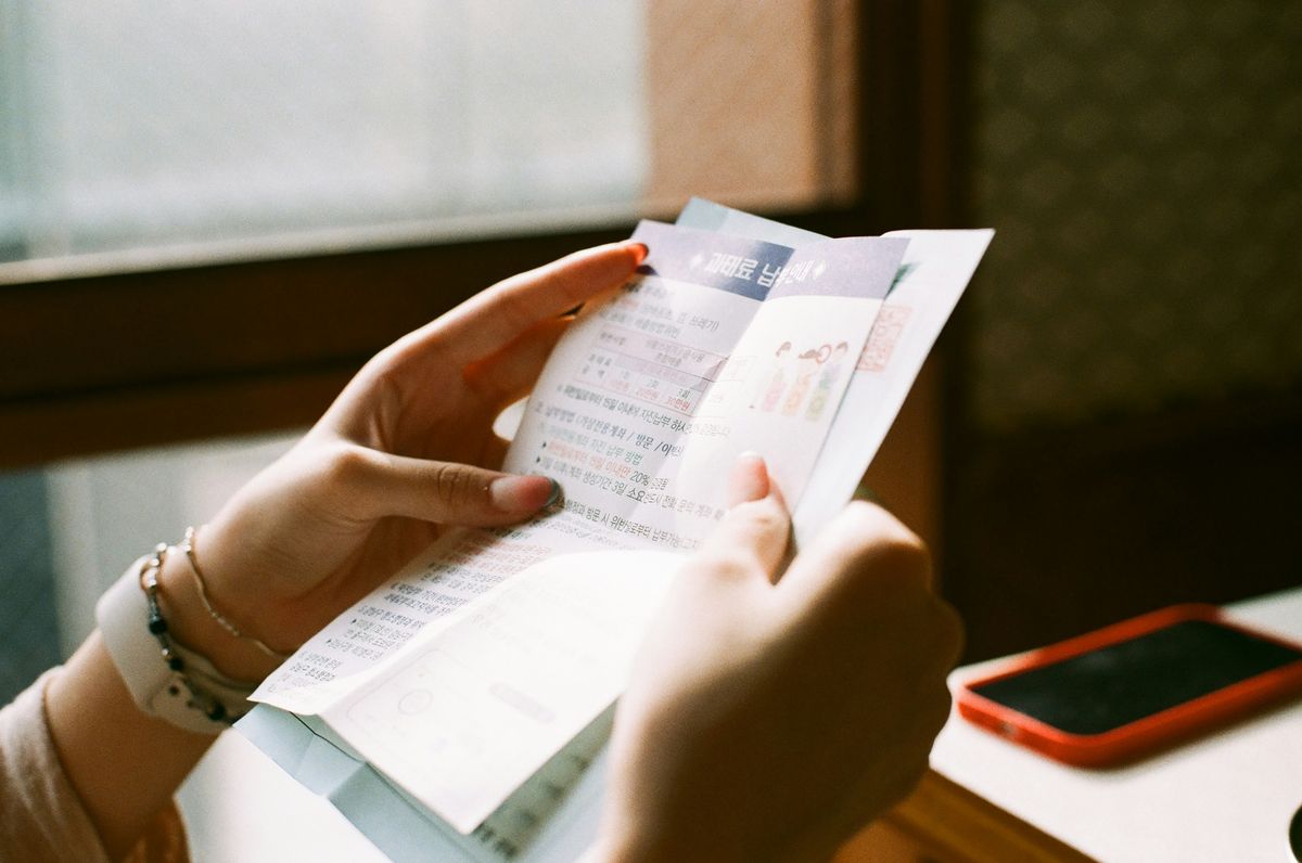 Woman reading a health insurance premium increase notice at home